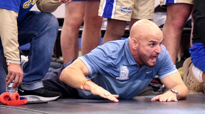 South Dade head coach Victor Balmeceda stirs his team on to victory during the Class 3A state championship duel at the FHSAA Duals this past season at Osceola High School in Kissimmee.